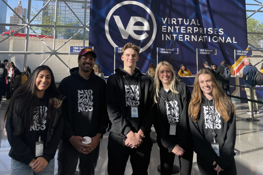 Empowering Future Leaders: DTG-C Proud Sponsor of San Juan Hills High School's NYC Nationals Journey 3 SJH VE team with sign landscape